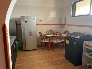 a kitchen with a table and a refrigerator and a table and chairs at Crisana - jerez in Floridablanca