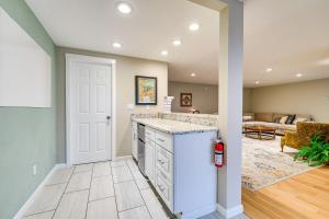 a kitchen with a white refrigerator and a living room at East Wenatchee Home about 2 Mi to Columbia River! in East Wenatchee