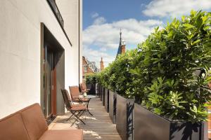 einen Balkon mit einem Tisch, Stühlen und Pflanzen in der Unterkunft Bulgari Hotel London in London