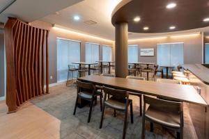 a group of tables and chairs in a room at SpringHill Suites Rochester Mayo Clinic Area / Saint Marys in Rochester +24 photos