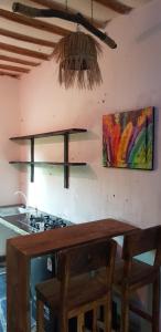 a kitchen with a stove and a painting on the wall at Edenic in Diani Beach