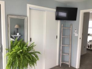 a room with a sliding door with a flat screen tv at Tregandale in Greytown