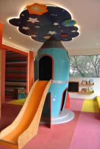 a childrens play area with a slide in a room at Cozy apartment in Mexico City. in Mexico City