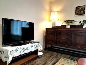 a living room with a flat screen tv and a dresser at Comfort Private Rooms in Three bedroom House in Bridgemary