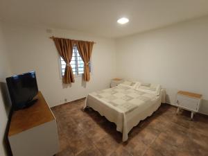 a bedroom with a bed and a flat screen tv at Casa Romo in San Rafael