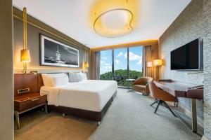 a bedroom with a bed and a desk and a computer at Radisson Collection Hotel, Vadistanbul in Istanbul
