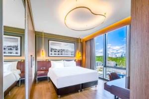 a hotel room with two beds and a large window at Radisson Collection Hotel, Vadistanbul in Istanbul