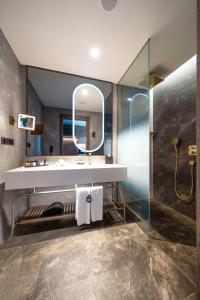 a bathroom with a sink and a mirror at Radisson Collection Hotel, Vadistanbul in Istanbul