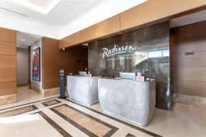 a restaurant with two reception desks in a lobby at Radisson Residences Avrupa TEM Istanbul in Istanbul