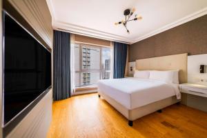 Postel nebo postele na pokoji v ubytování Radisson Residences Avrupa TEM Istanbul