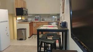 a kitchen with a table and some stools in it at Broomfield Home in Broomfield