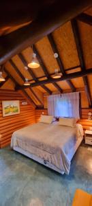 a bedroom with a large bed in an attic at Ecos da Terra Chalés in Monte Verde +95 photos
