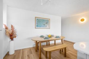 a dining room with a table and a sink at Maroochydore Beachfront in Maroochydore