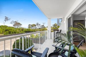 a balcony with chairs and a view of the ocean at Maroochydore Beachfront in Maroochydore
