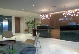 a hotel lobby with a reception desk and chairs at HIGI HOTEL SÃO PAULO in Sao Paulo