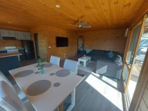 an overhead view of a living room with a table and chairs at Bushland Cabin near Town, River and Restaurants in Echuca