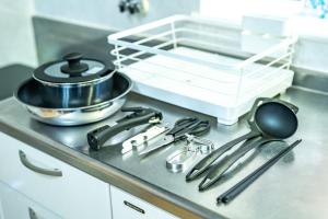 a bunch of utensils sitting on a stove in a kitchen at Sun Route Hirano-cho, サンルート平之町 in Kagoshima