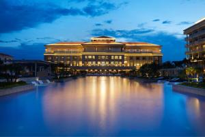 a large building with a pond in front of it at Sheraton Grand Danang Resort & Convention Center in Danang