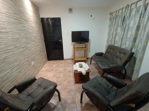 a living room with couches and a flat screen tv at Casa Romo in San Rafael