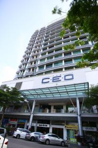 a large building with cars parked in front of it at Private Zen at The CEO Bayan Lepas Penang in Bayan Lepas