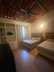 1 Schlafzimmer mit 2 Betten und einem Deckenventilator in der Unterkunft Rancho 3 marias in Córdoba