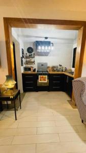a kitchen with black cabinets and a stove top oven at Cozy house in Buena Vista Jarabacoa in Buena Vista