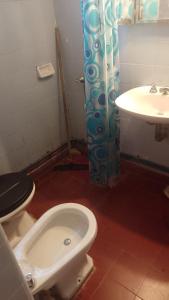 a bathroom with a toilet and a sink at Chalet cuesta blanca in Villa Icho Cruz