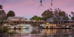 a train on a bridge over a river with boats at Bushland Cabin near Town, River and Restaurants in Echuca