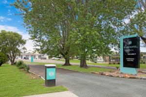 a sign on the side of a road at Hive Hotel, Moruya in Moruya