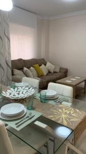 a living room with a table and a couch at Apartamento Parquesol in Antequera