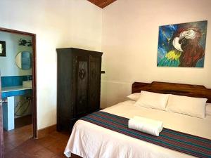 une chambre avec un lit et un tableau au mur dans l'établissement Rio Lindo Hotel, à Dominical