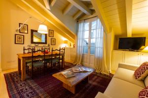 a living room with a table and a couch at White Pine Lodge Livigno in Livigno