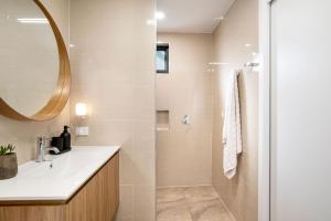 a bathroom with a sink and a mirror at Eco Bee Studio in Garden Serenity in Thebarton