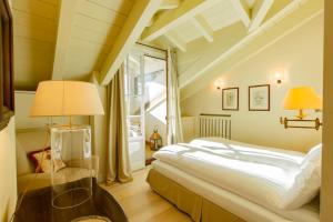 a bedroom with a large bed and a window at White Pine Lodge Livigno in Livigno