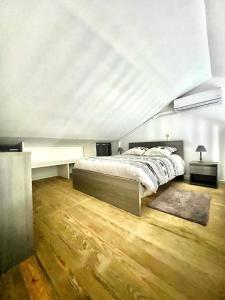 a bedroom with a bed and a white ceiling at Duplex Marina gosier- vue Mer et bateaux in Le Gosier