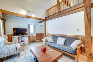 a living room with a couch and a table at Jones Mills Vacation Rental Near Skiing and Hiking! 