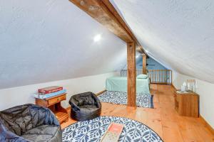 a attic room with two beds and a table at Jones Mills Vacation Rental Near Skiing and Hiking! 