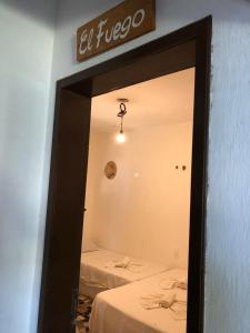 a mirror in a room with two beds at ITACUPA - Healthy VEGAN & FOIL Center in Cumbuco