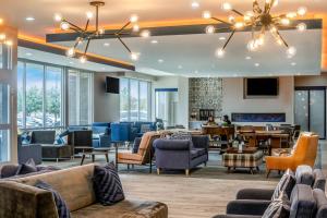 a lobby with couches and chairs and a table at Four Points by Sheraton Plano in Plano