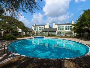 a swimming pool with a wooden deck next to a building at Reel Mermaid in Rockport