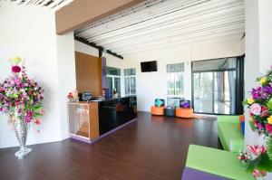 a lobby with a vase of flowers in a room at FIG Boutique Hotel in Kamphaeng Phet