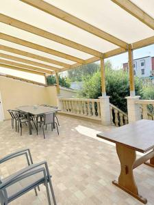 a pavilion with tables and chairs on a patio at 7 chambres Paris Disneyland in Chelles