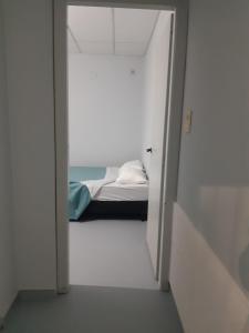 a door leading into a room with a bed in it at Dpto en San Antonio Oeste 3 pax in San Antonio Oeste