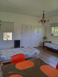 a bedroom with two beds and a tv in it at Loft Las Acacias in Potrero de los Funes