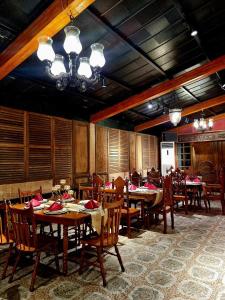 a dining room with tables and chairs in a restaurant at Residencia Orlina in Dumaguete