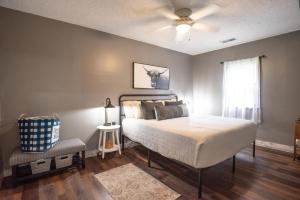 a bedroom with a bed and a ceiling fan at Harper Valley Cottage in Nashville