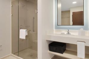 a bathroom with a sink and a shower at Courtyard by Marriott San Jose Airport Alajuela in Alajuela City