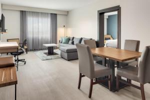 a living room with a table and a couch at Courtyard by Marriott San Jose Airport Alajuela in Alajuela City