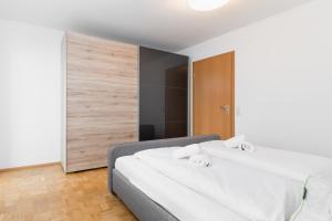 a bedroom with two beds with white sheets at Untersee-Suite IStayUnixI Seenähe-Terrasse-Workspace-Netflix-Parkplatz in Radolfzell am Bodensee