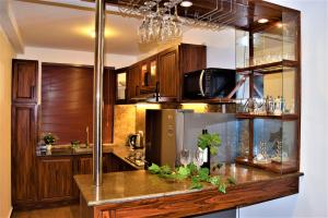 a kitchen with wooden cabinets and a counter top at Infinity Condos by Lake Infinity in Nuwara Eliya